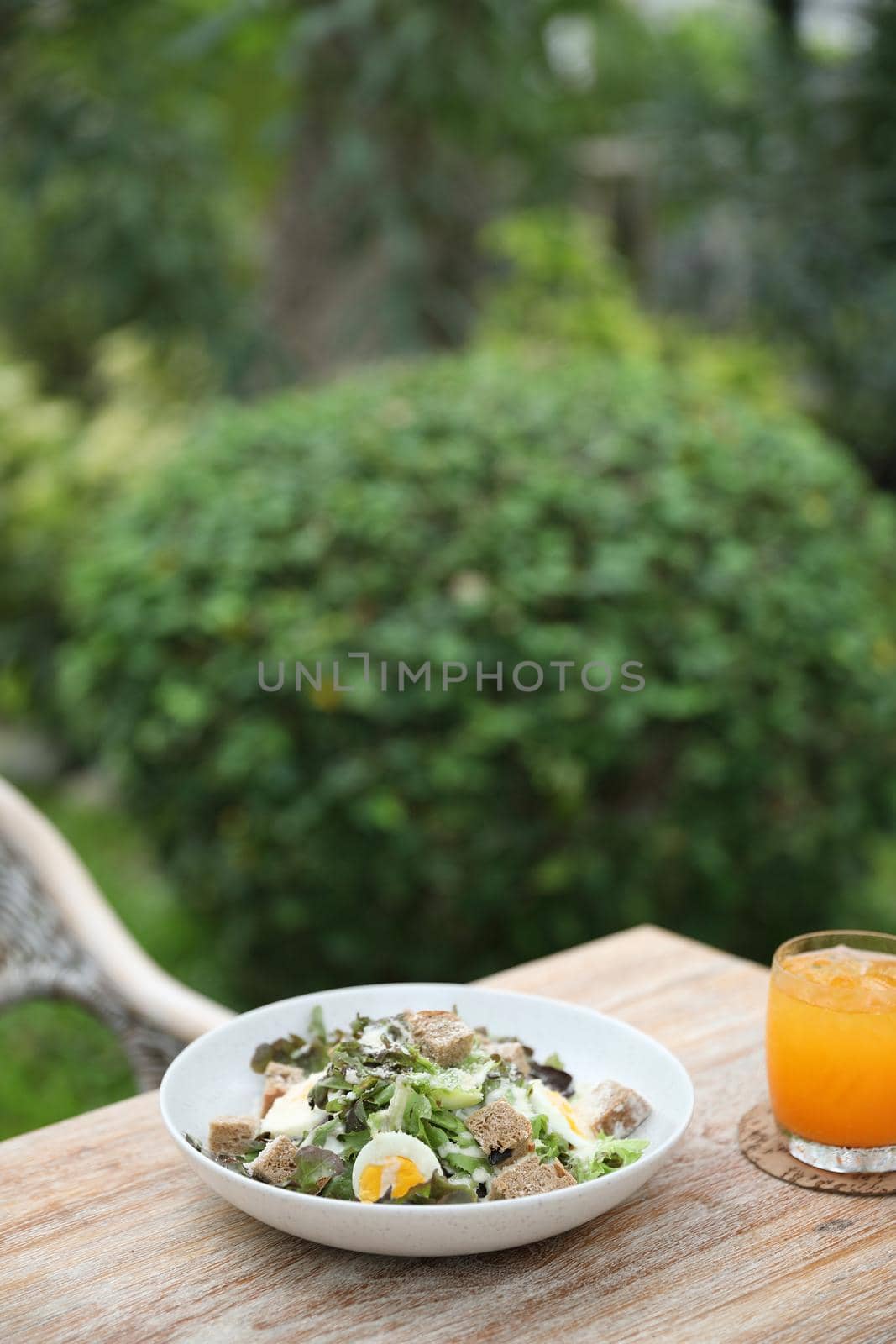 caesar salad appetizer on wooden background by piyato