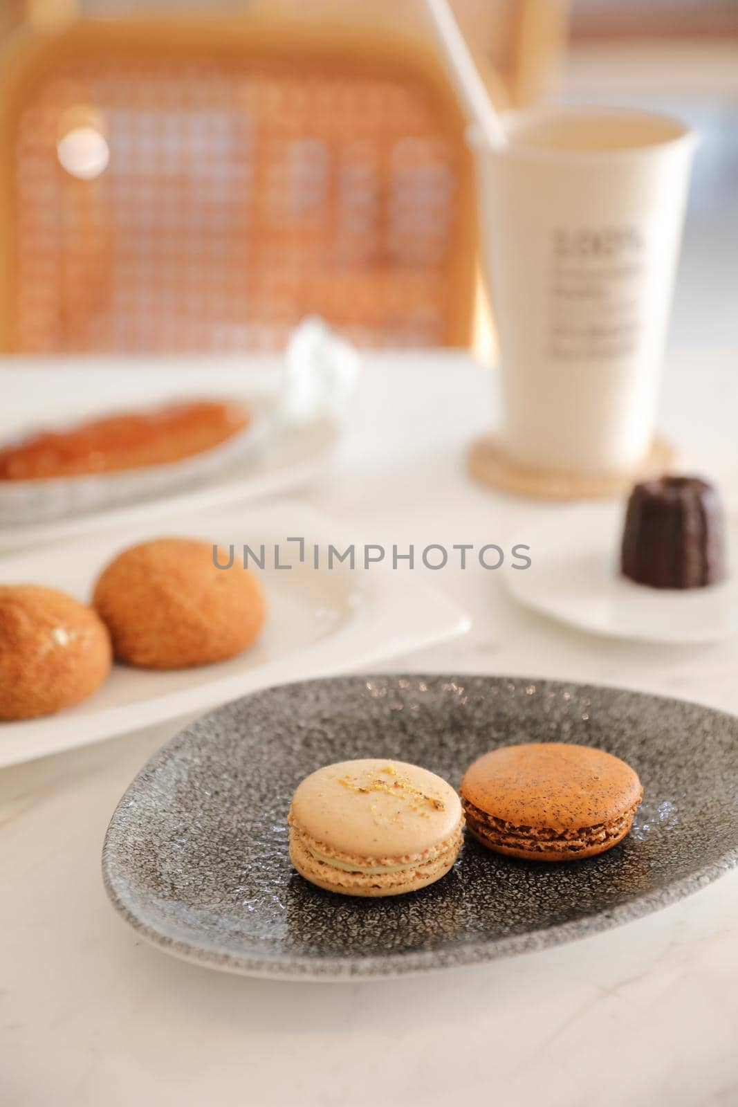 brown macaron dessert in coffee shop background by piyato