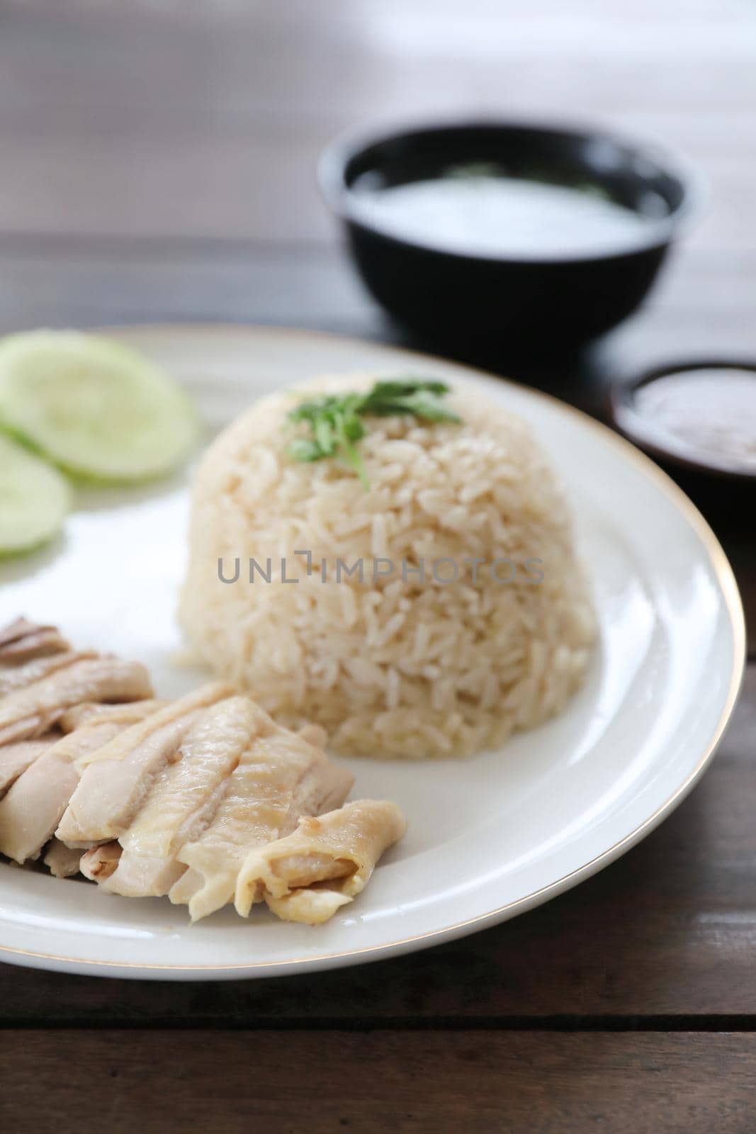 Thai food gourmet steamed chicken with rice khao mun kai in wood background  by piyato