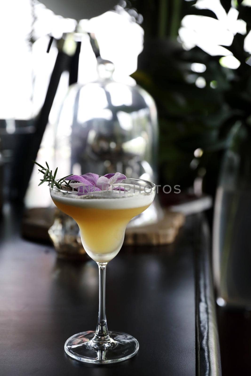 Pink Cocktail glass with ice at a bar counter by piyato