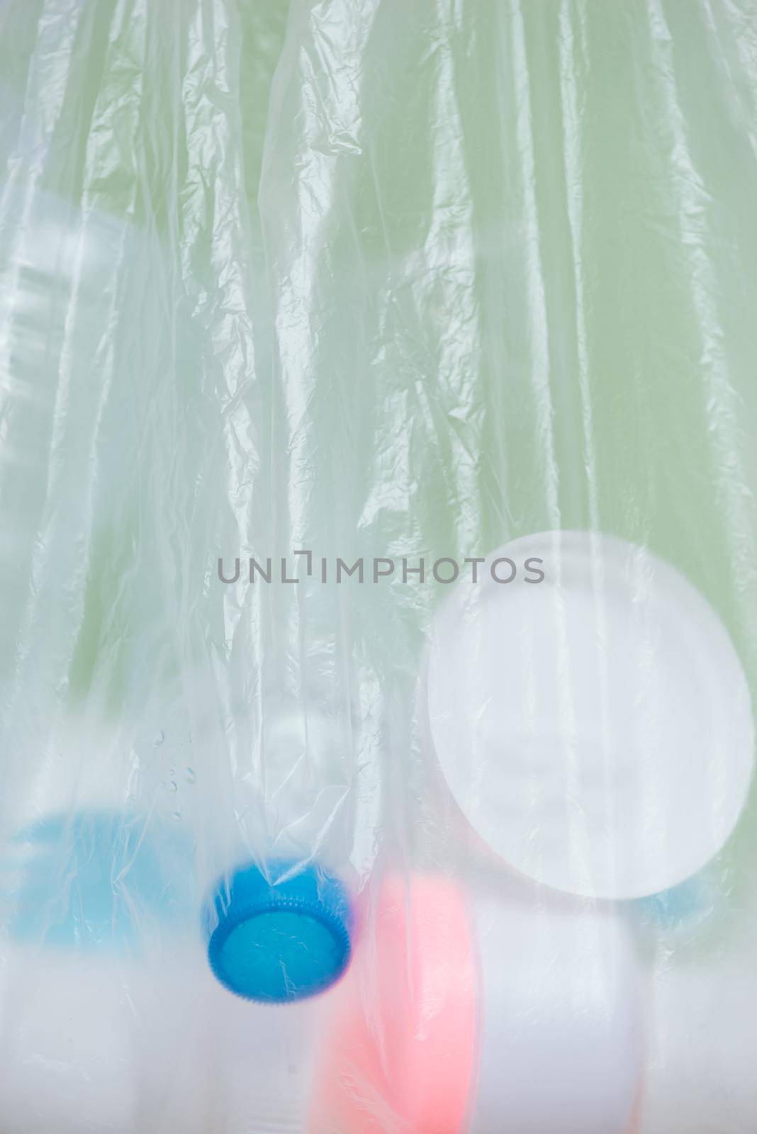 Plastic bag filled with household waste isolated on white background.