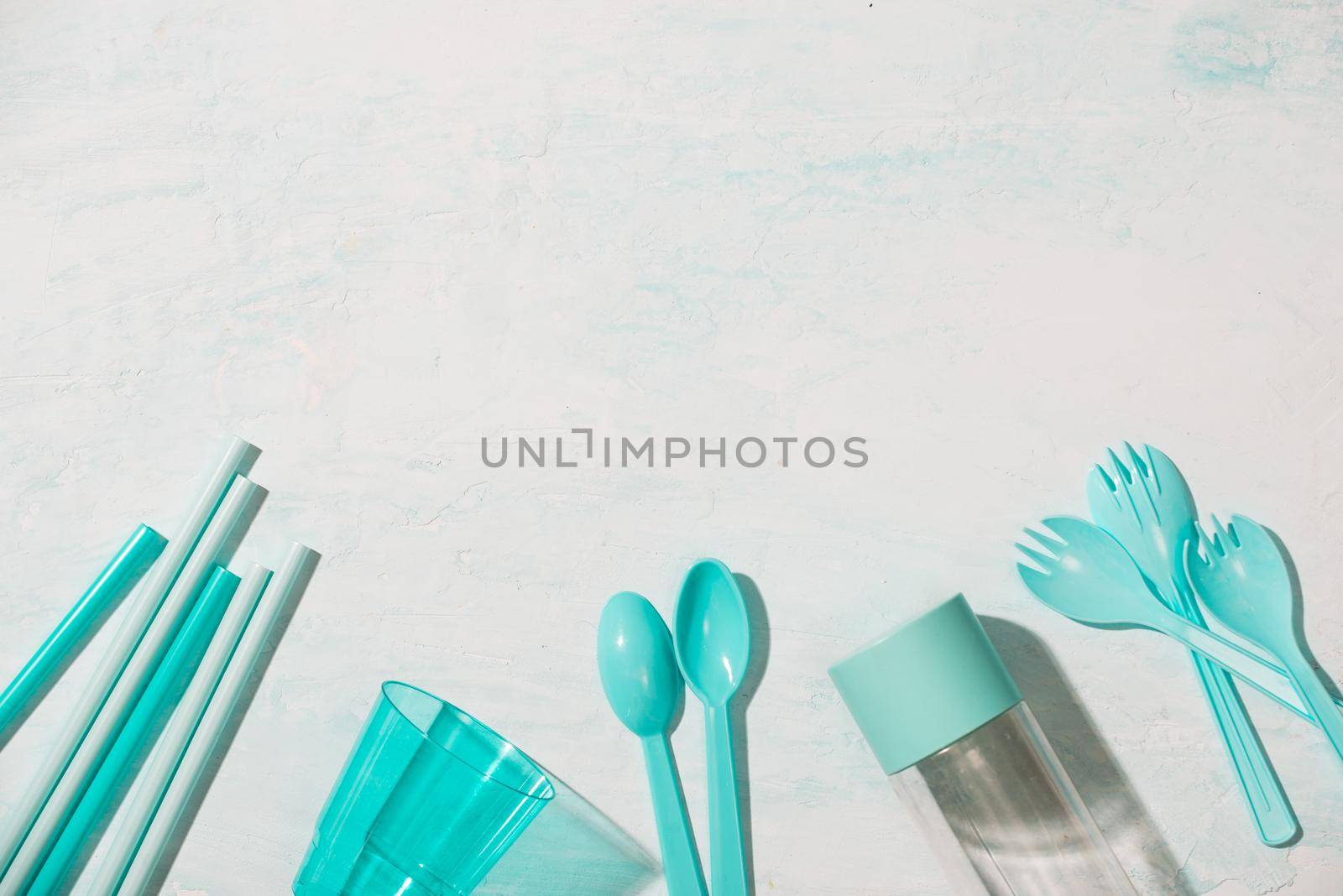 No plastic recycle concept blue plastic dishes plates cups spoon isolated white background, copy space, top view by makidotvn