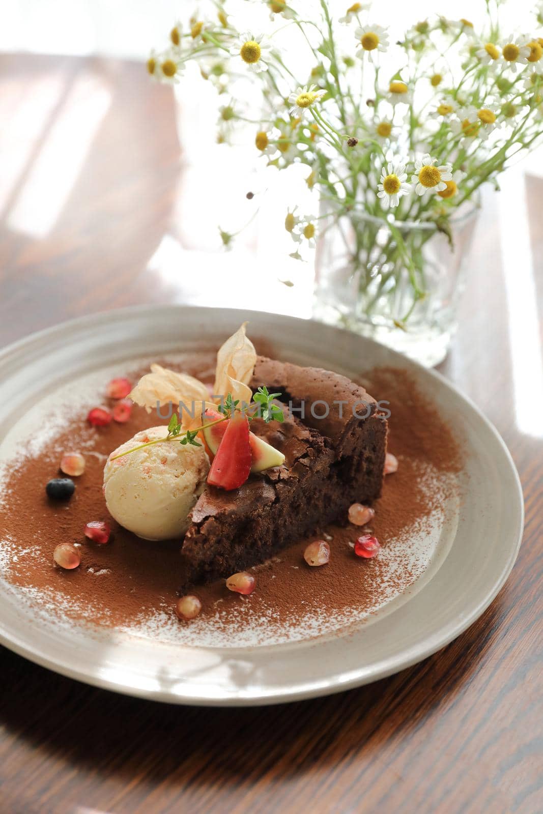 Chocolate cake with ice cream dessert on wood table  by piyato