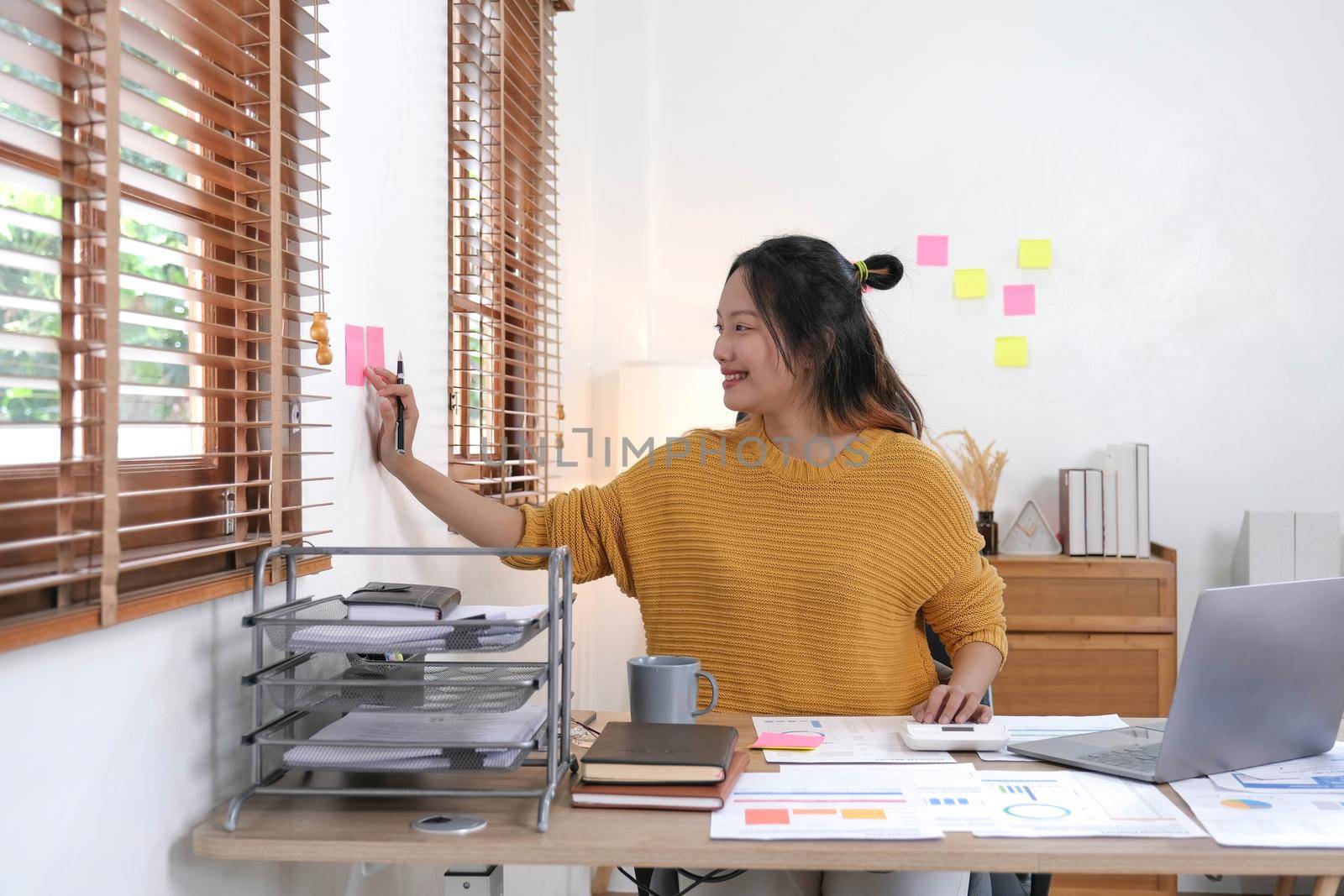 Sticky note paper reminder schedule board. Accountant or business use post it notes to share idea on sticky note. Accounting concept.