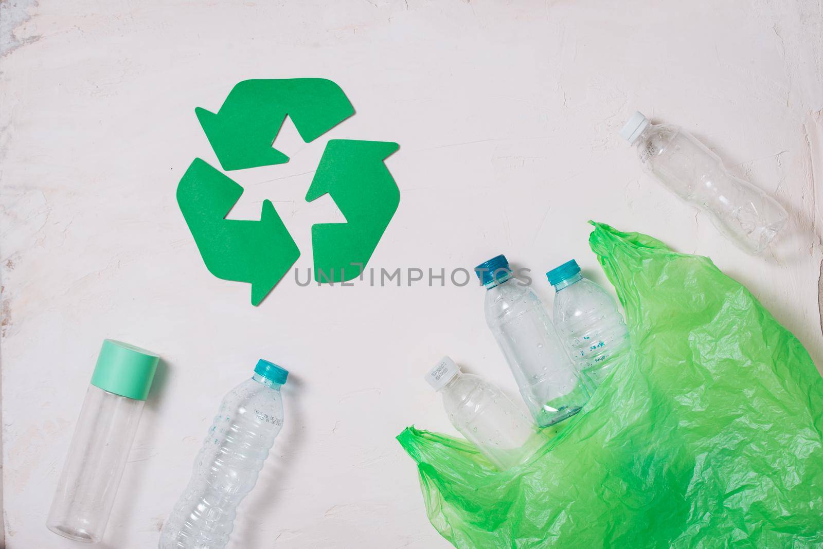 waste recycling eco symbol with garbage disposal on stone table background top view by makidotvn