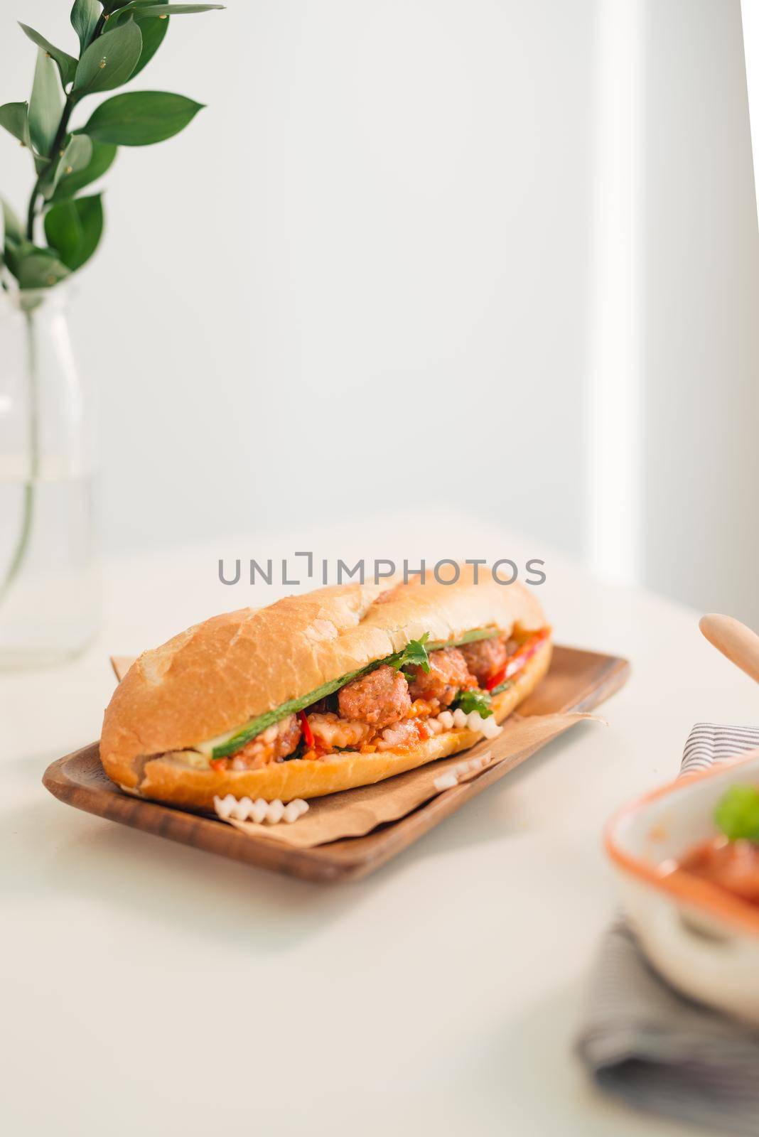 Banh Mi Xiu Mai - Vietnamese sandwich with meatballs in tomato sauce, do chua (radish and carrot pickle), cucumber and coriander.