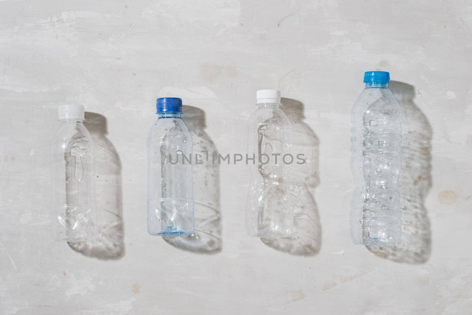 close up of used plastic bottles on white background 