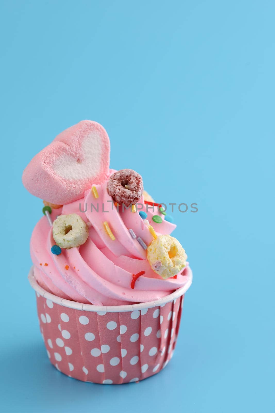 pink cupcake isolated in blue background by piyato
