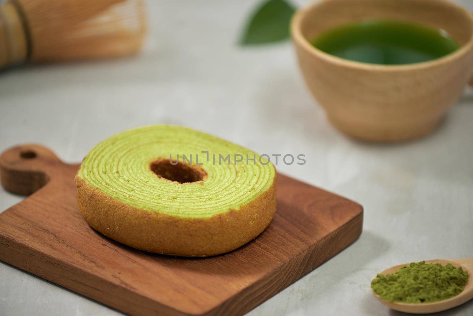 Close up on green matcha Baumkuchen Japanese roll cakes, selective focus