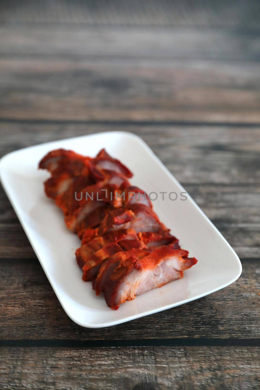 Roasted pork thai local food with red sauce on wood background