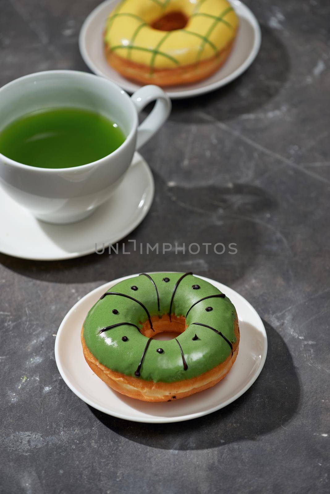 Matcha and white chocolate donuts with matcha tea latte