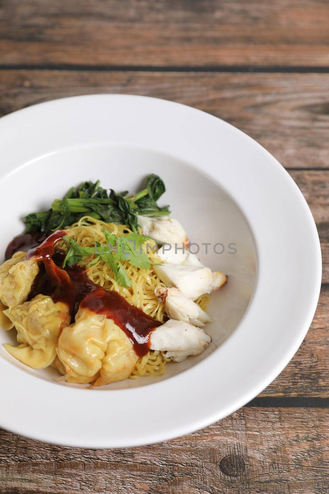 Shrimp dumpling noodles and crab meat on wood background