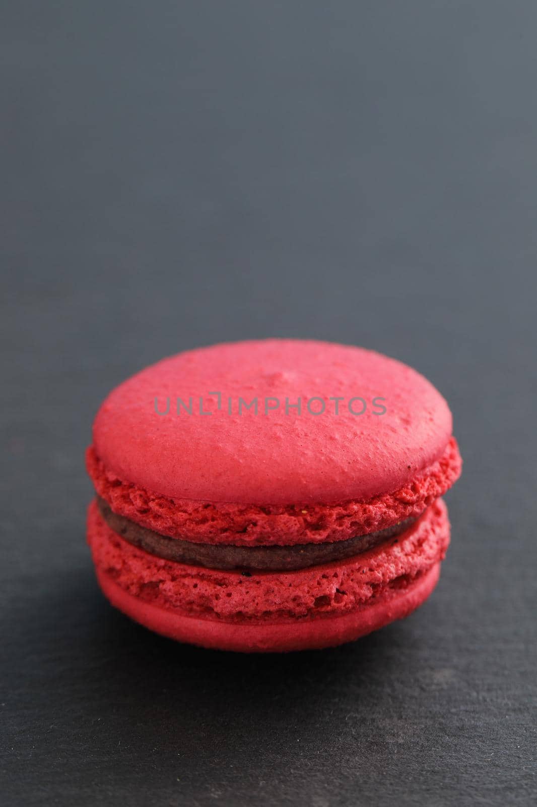 Colorful macarons isolated in black background