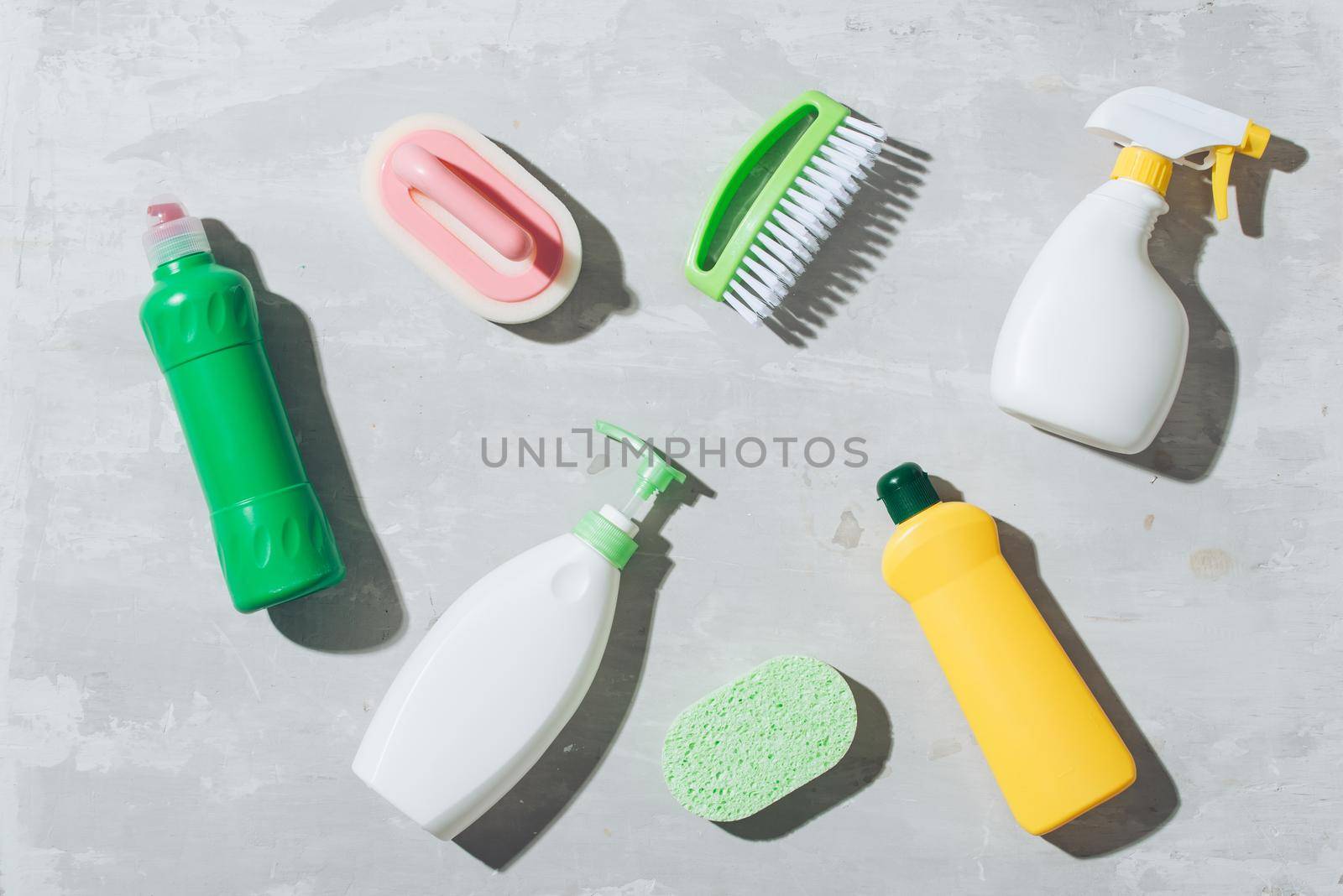 House cleaning products on wooden table. Salt pelets, baking soda (sodium bicarbonate), detergent, spray by makidotvn