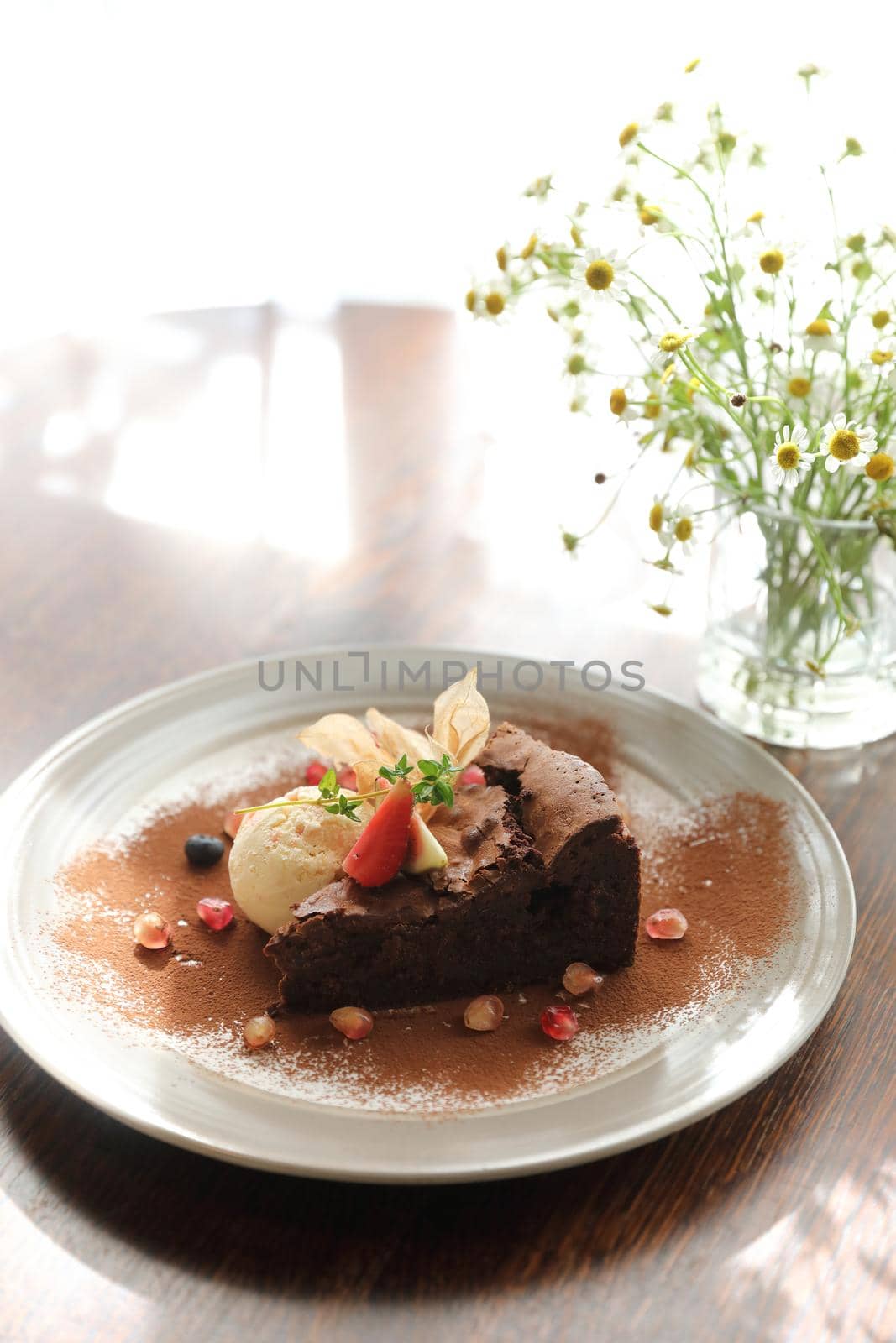 Chocolate cake with ice cream dessert on wood table  by piyato