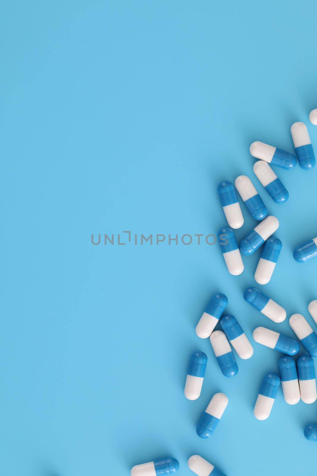 pills capsules isolated on blue background by piyato