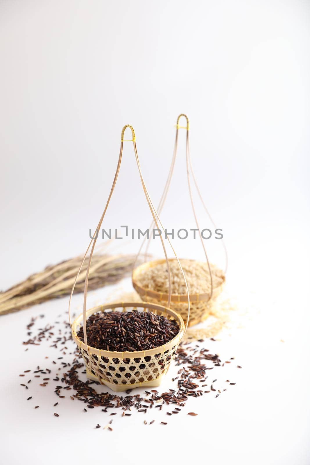 Organic raw brown rice and riceberry rice on Wicker basket in close up