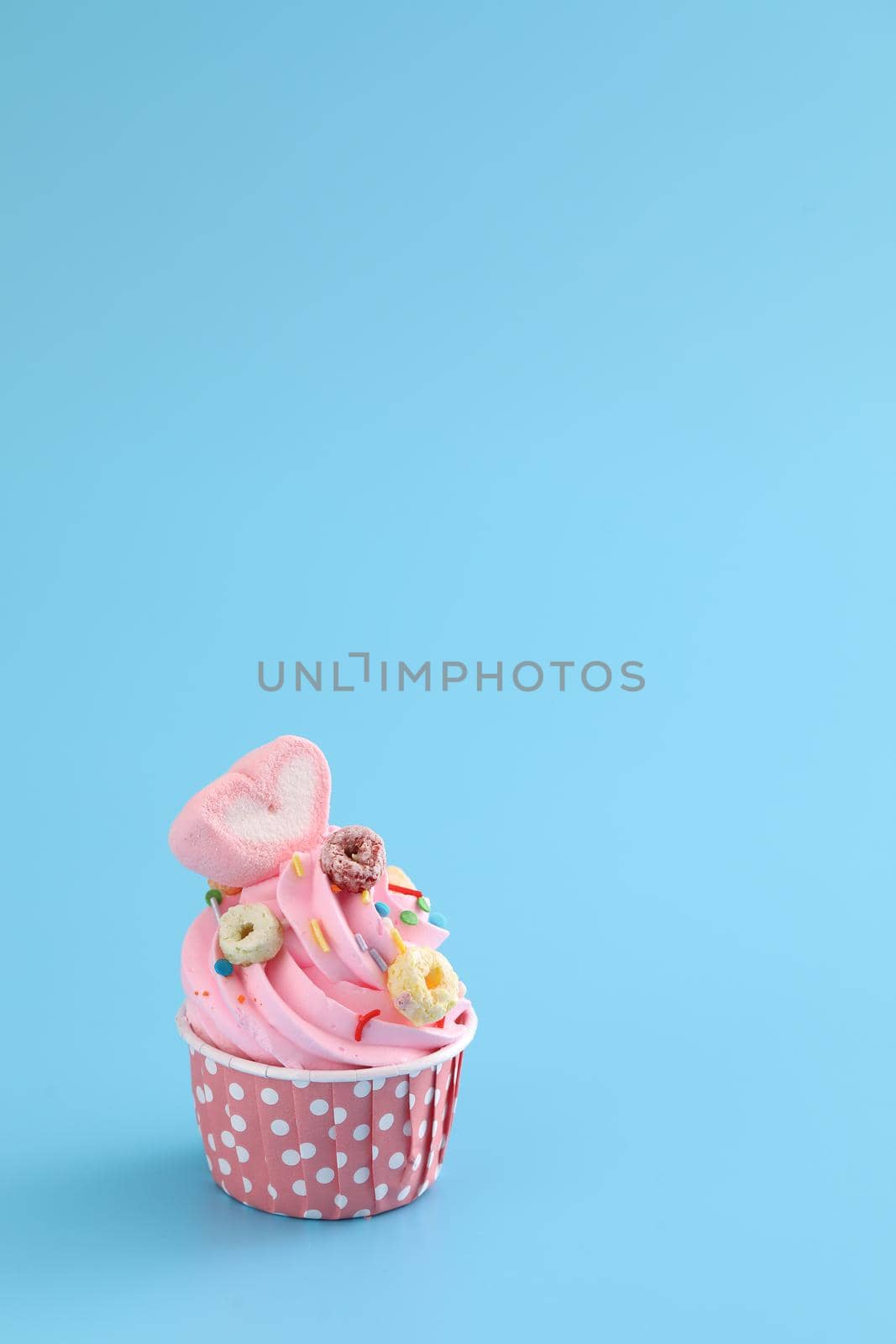 pink cupcake isolated in blue background by piyato