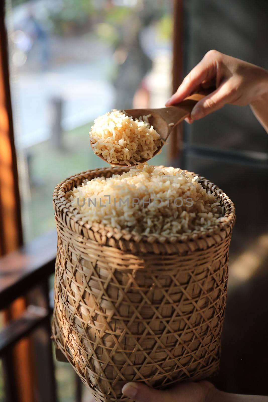 Organic boiled brown rice on Wicker basket in close up by piyato