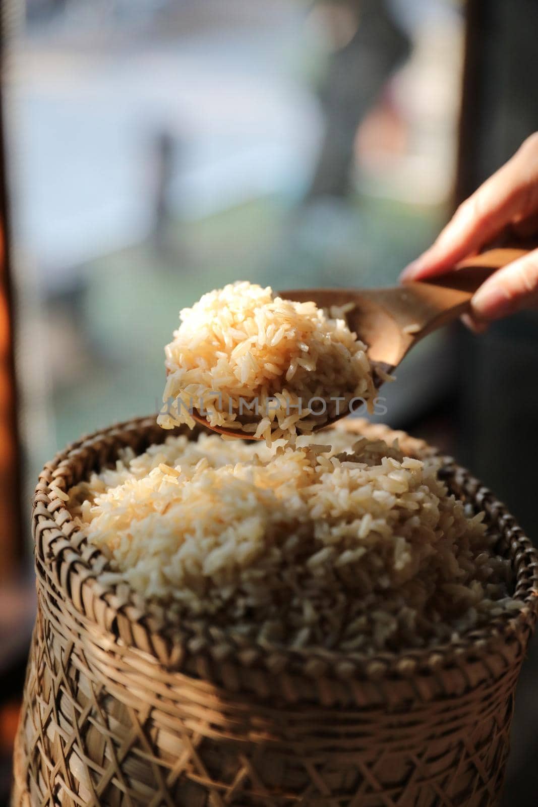 Organic boiled brown rice on Wicker basket in close up by piyato