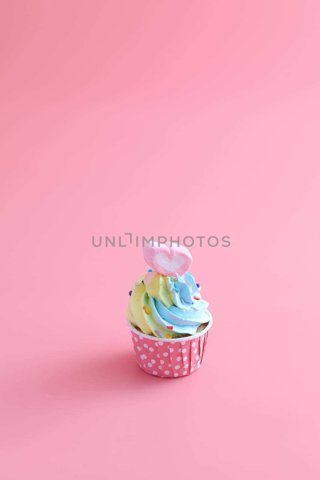colorful cupcake isolated in pink background by piyato