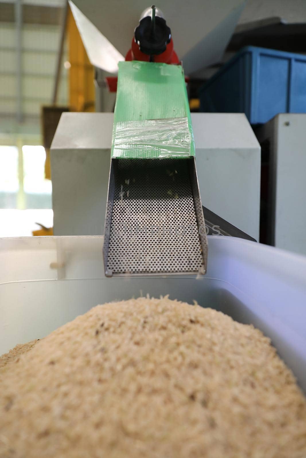 Factory machine Milling rice in close up by piyato