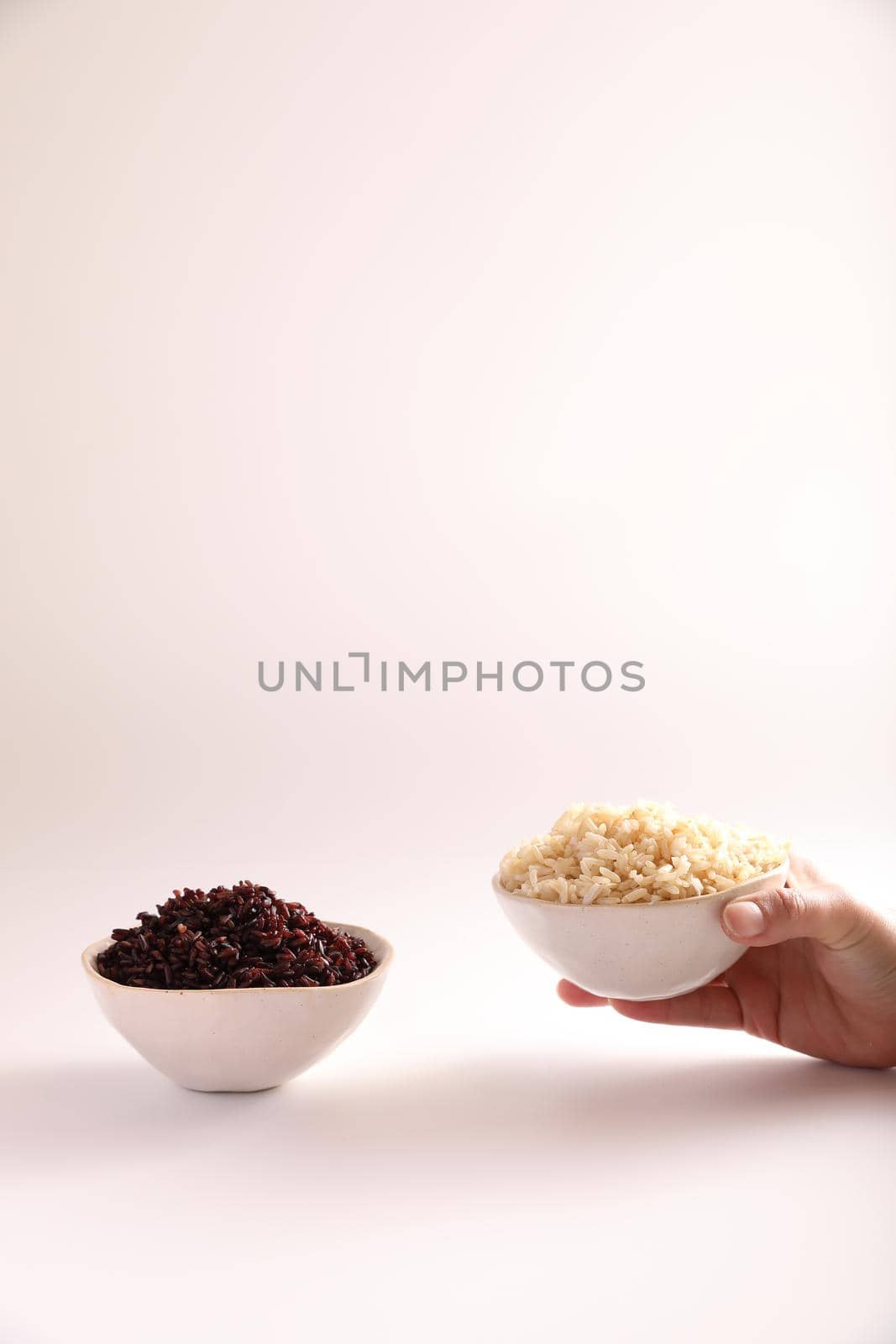 Organic boiled brown rice on bowl isolated in white background by piyato
