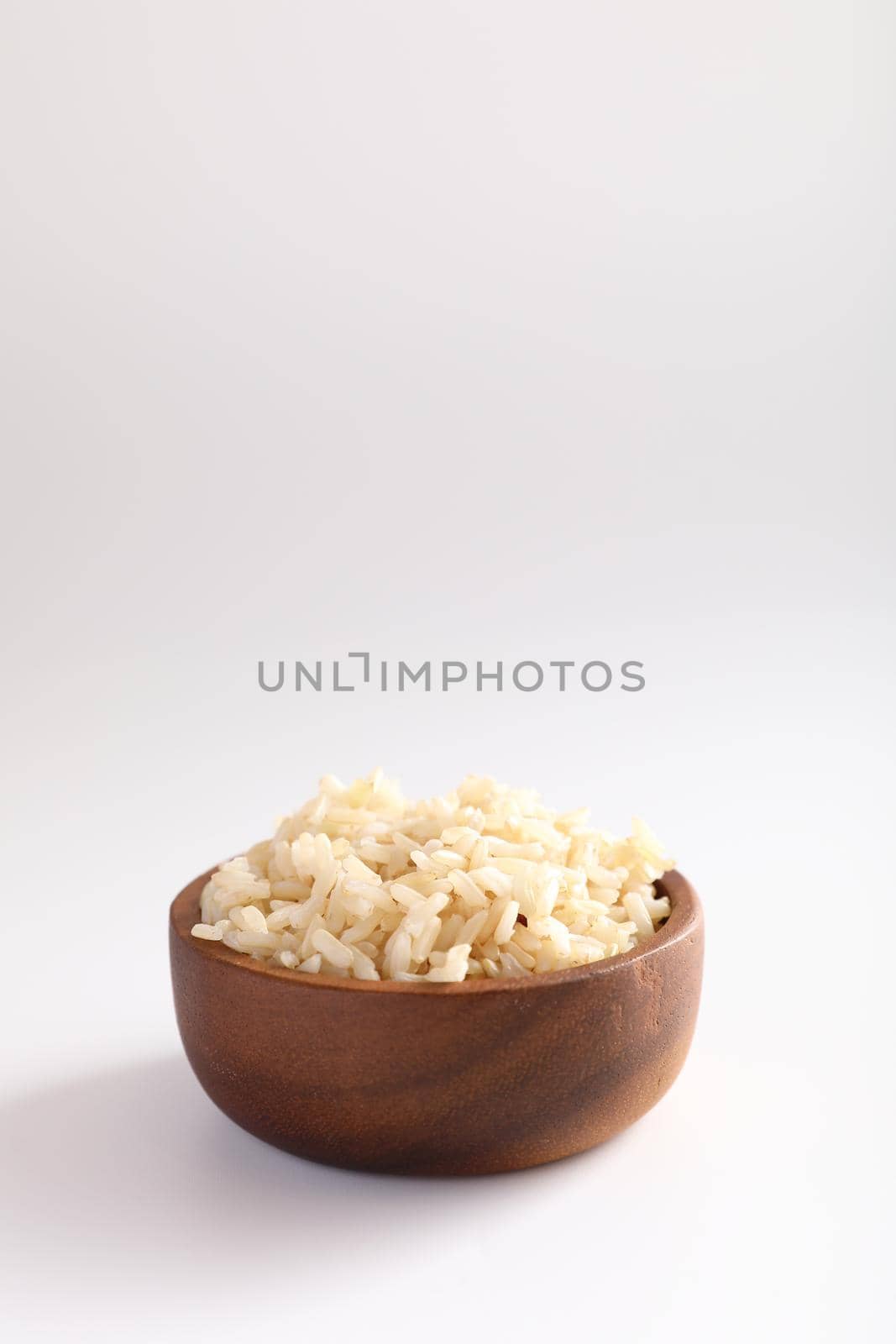 Organic boiled brown rice on bowl in close up by piyato