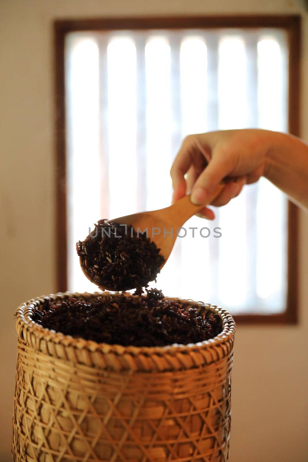 Boiled riceberry rice on Wicker basket with spoon in close up