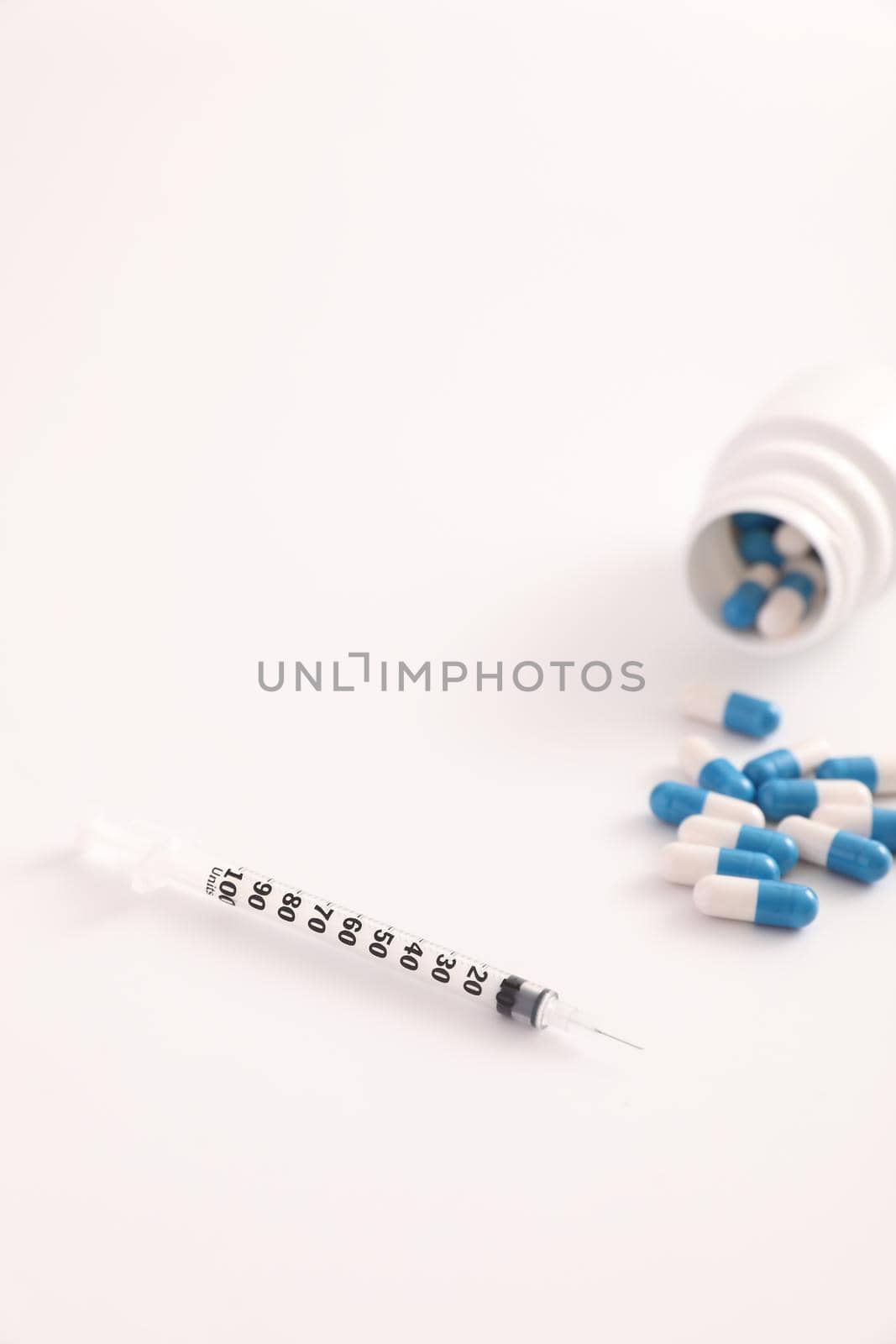 Syringe and pill isolated in white background