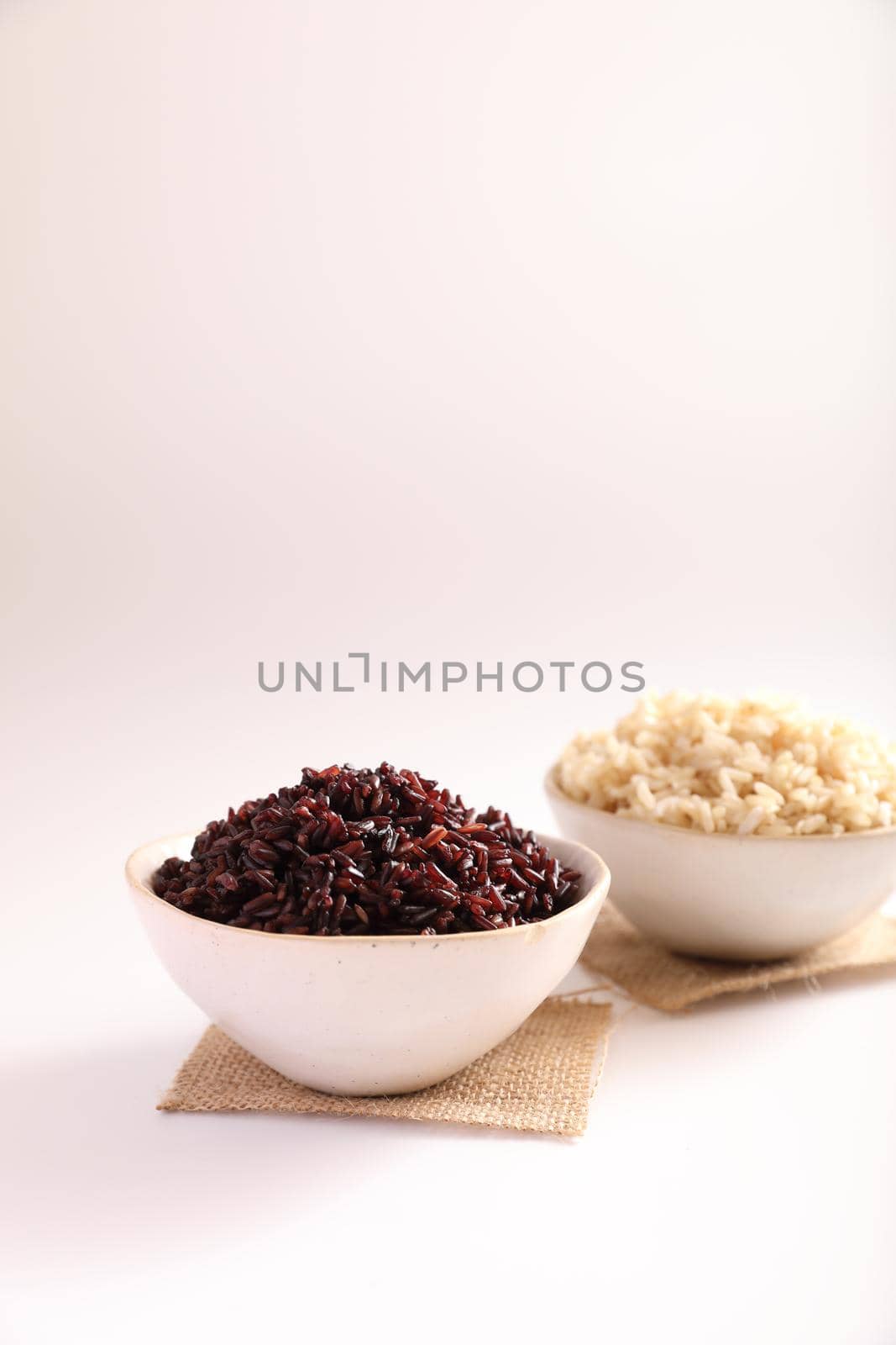 Organic boiled brown rice on bowl isolated in white background