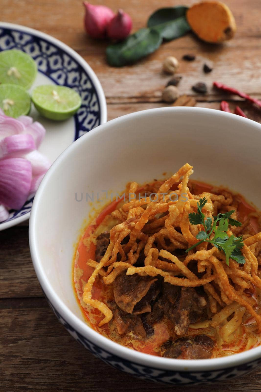 Local northern Thai food Egg noodle curry with beef on wood background