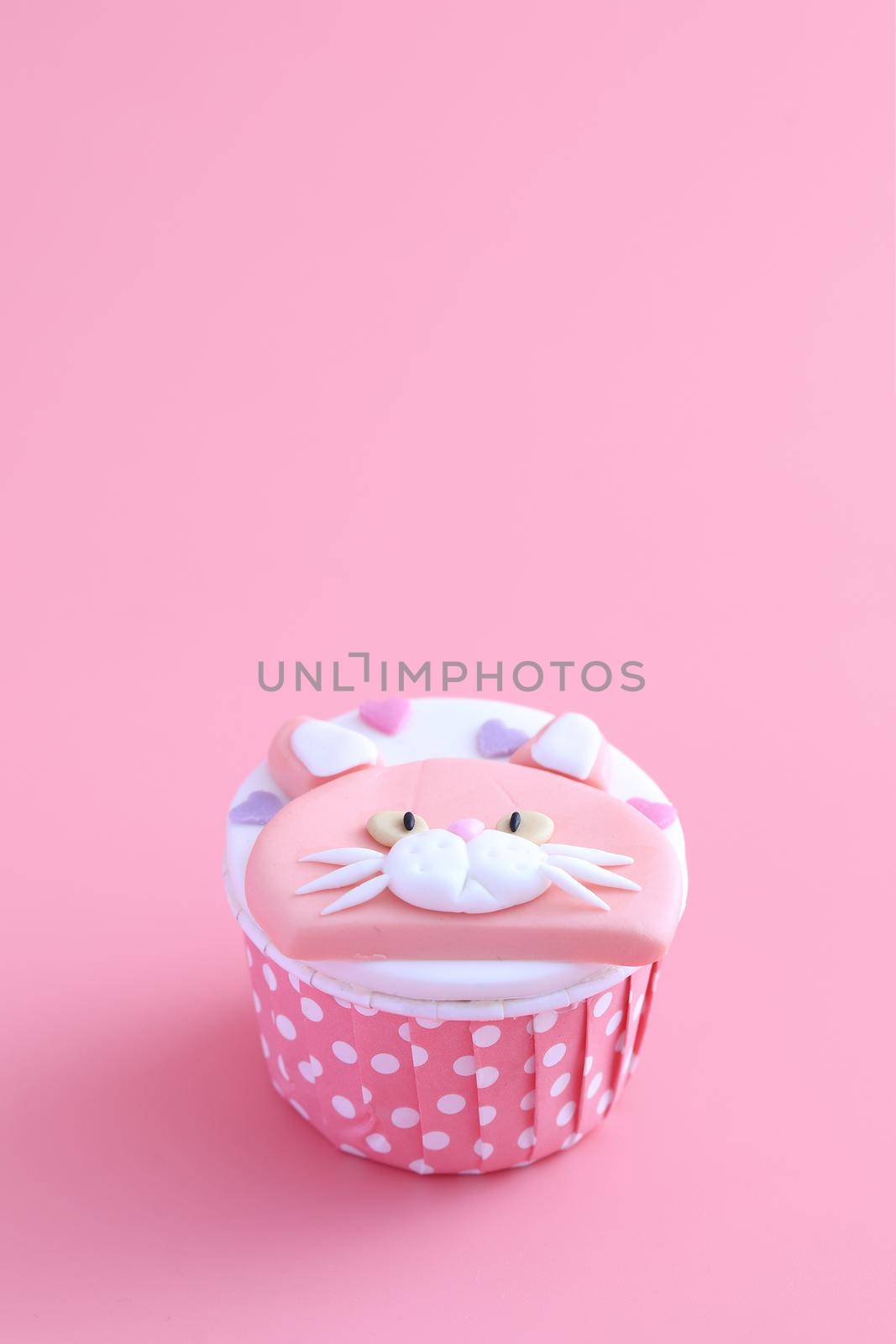 cupcake isolated in pink background by piyato