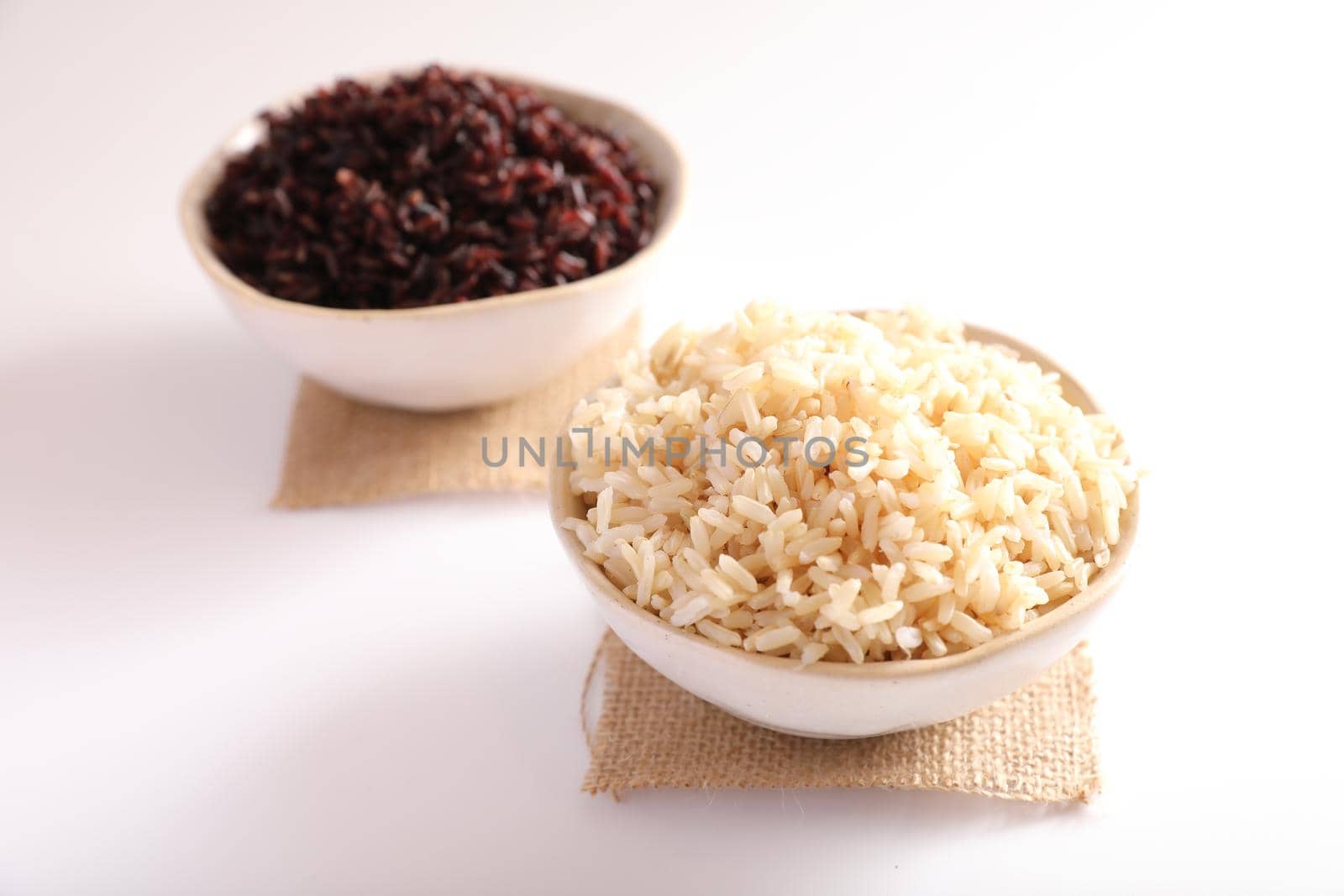 Organic boiled brown rice on bowl isolated in white background