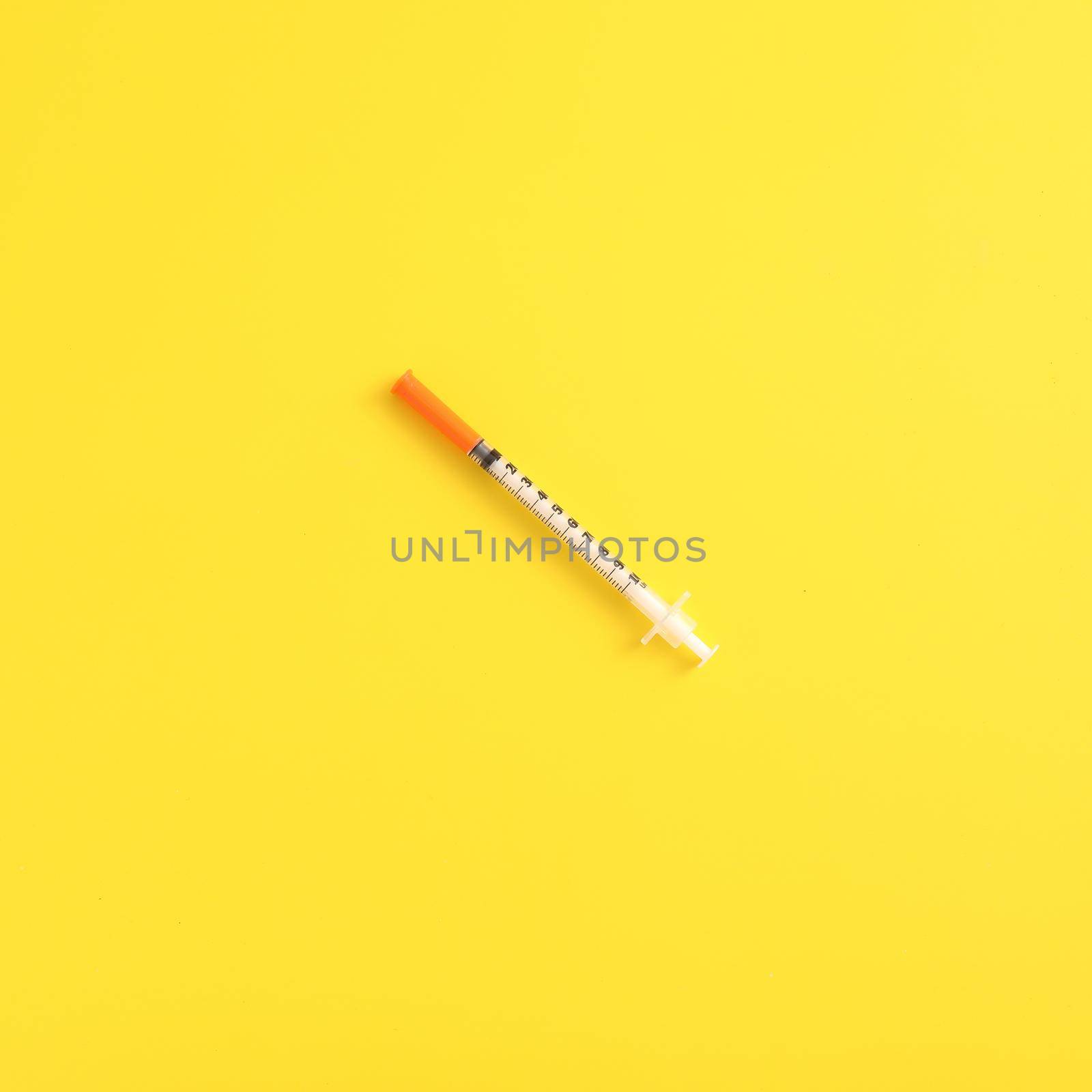 Syringe vaccine isolated in yellow background