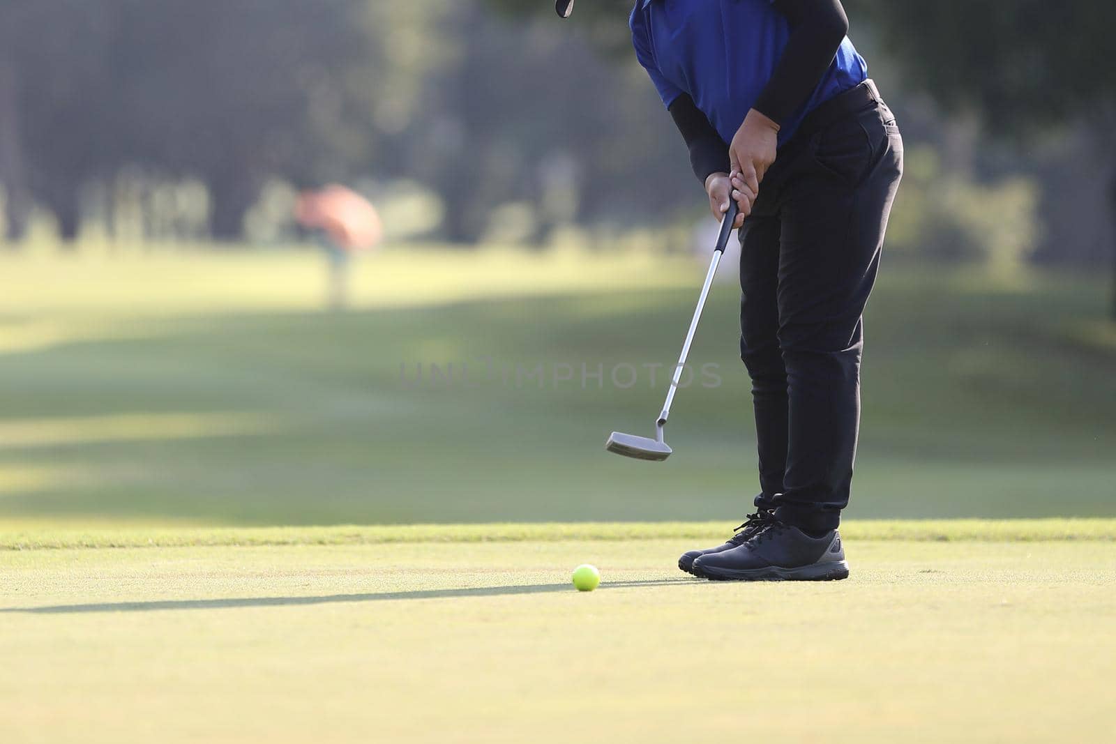 Young male golfer player on golf course