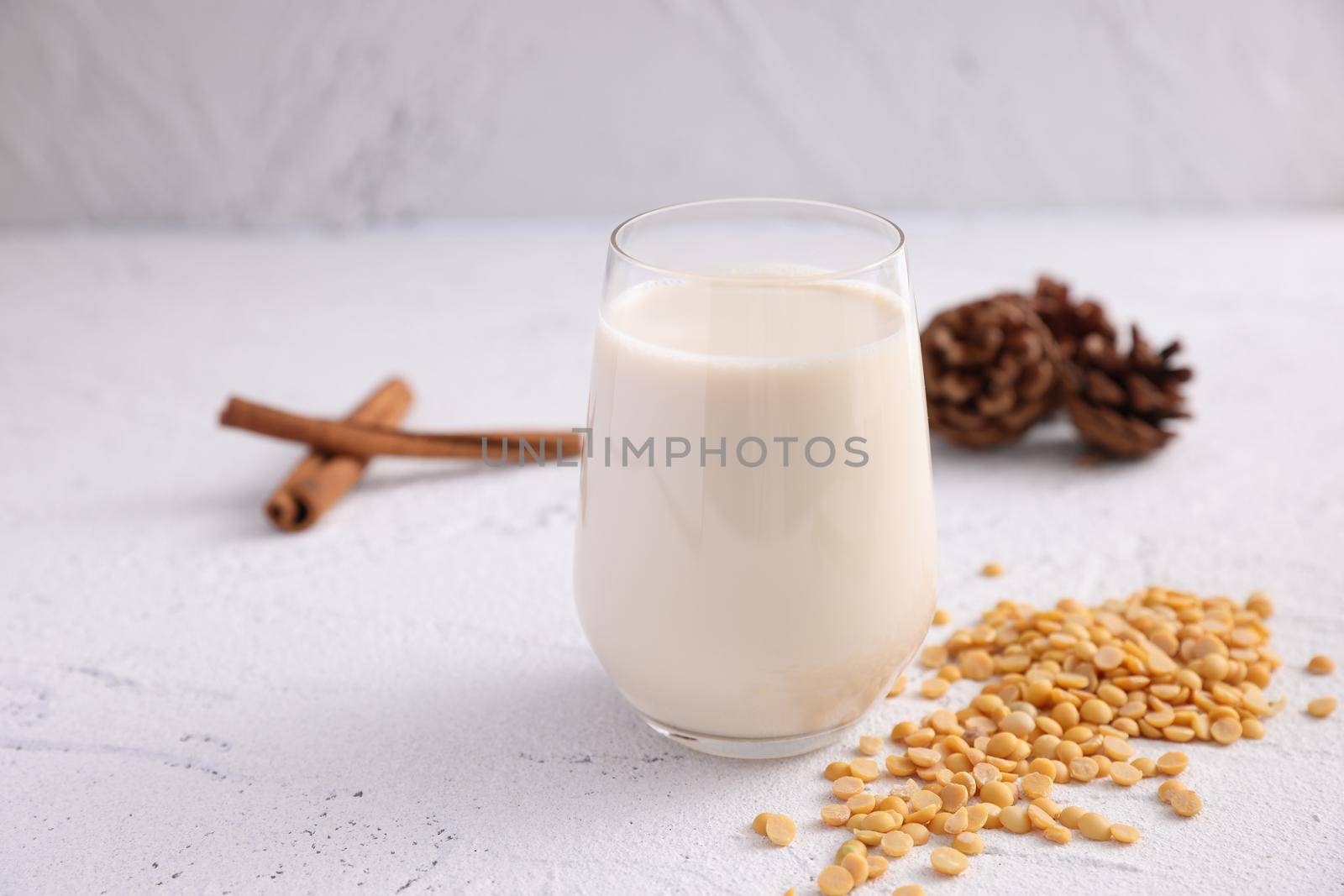 Soy milk in glass and soy bean isolated in white background