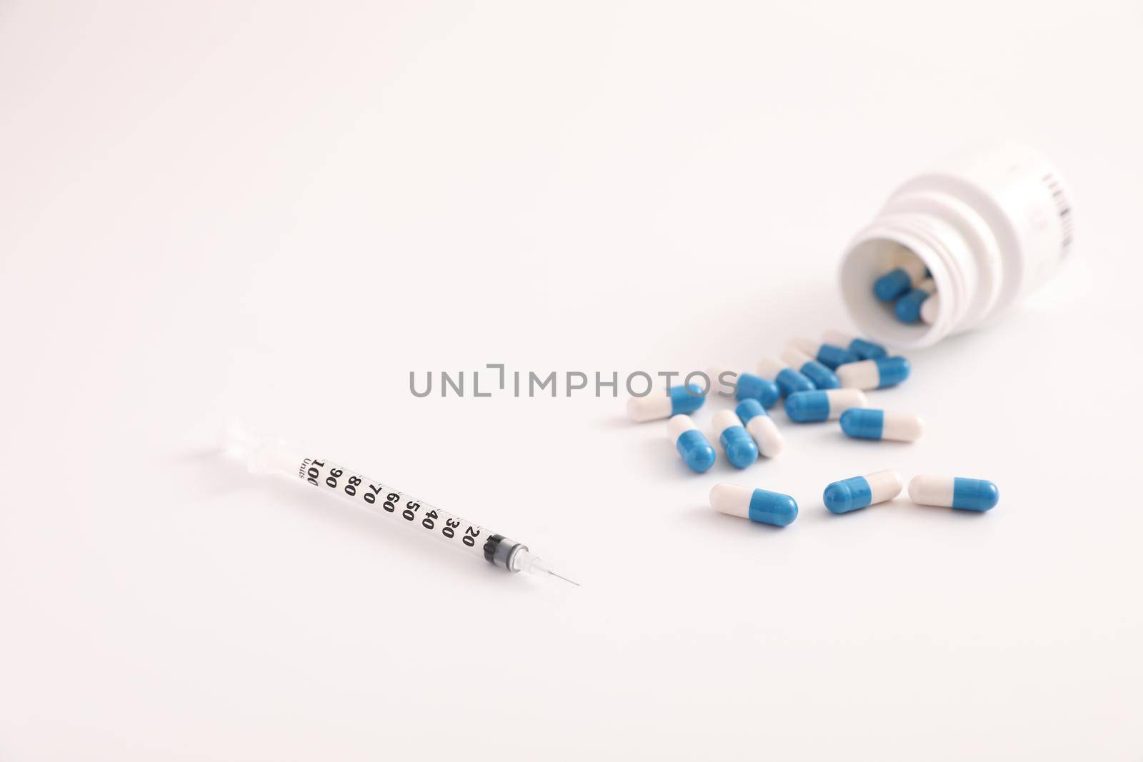 Syringe and pill isolated in white background