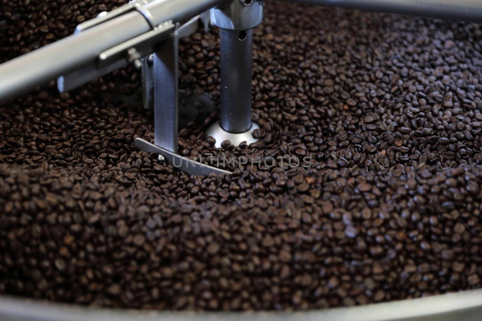 Coffee beans roasting with machine in close up