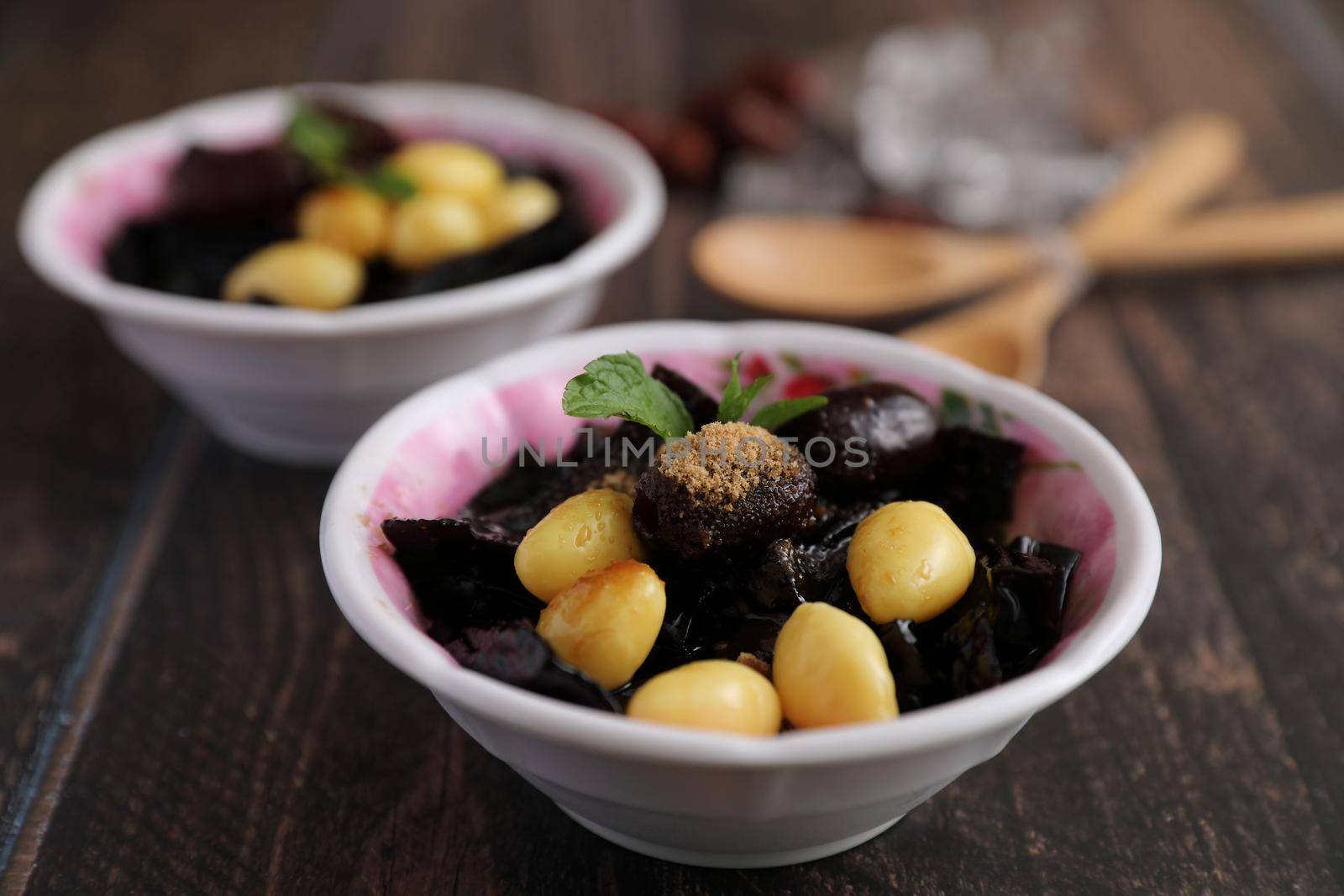 Local Thai dessert glass jelly isolated in wood background by piyato