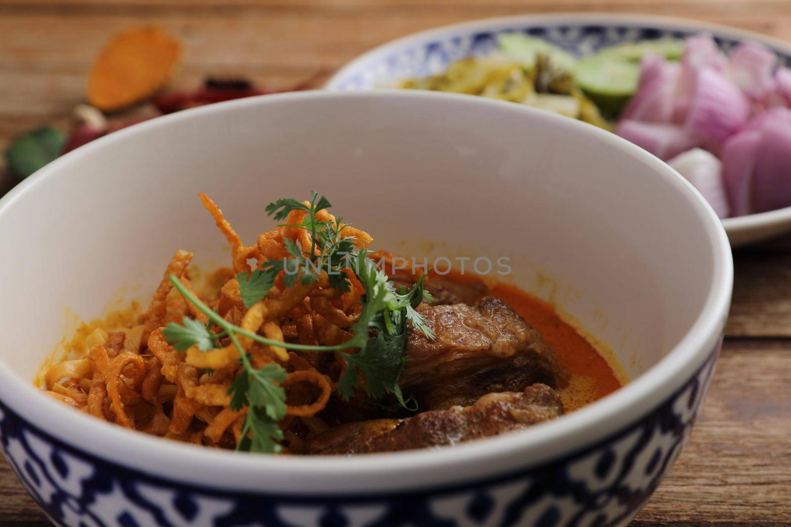 Local northern Thai food Egg noodle curry with pork ribs on wood background by piyato