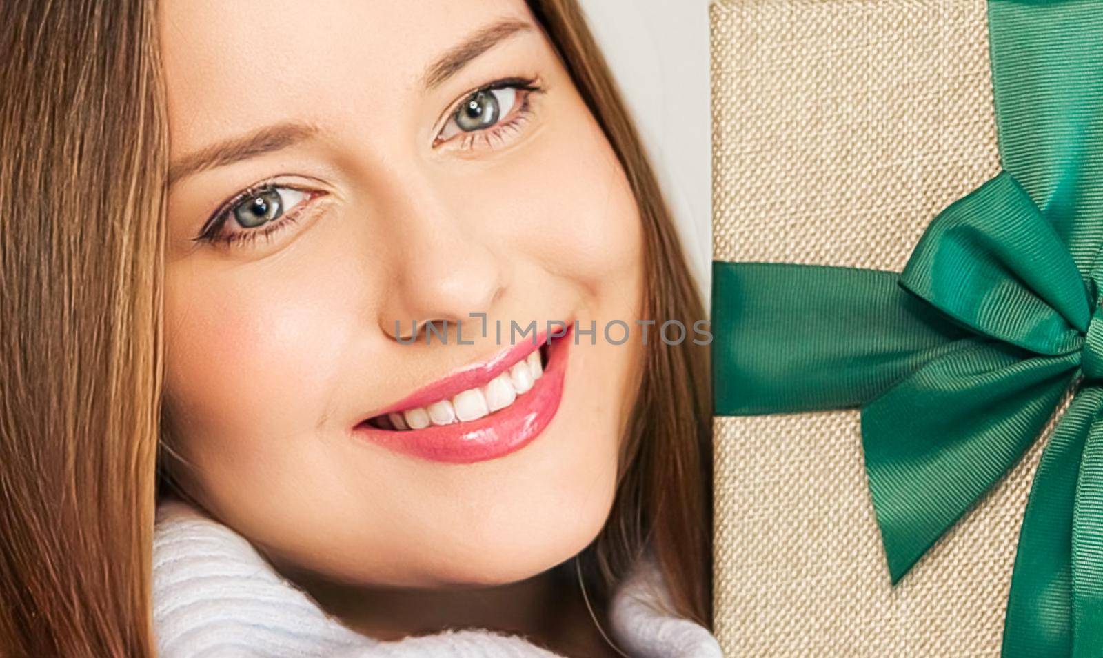 Winter holidays, present and Merry Christmas concept, happy woman smiling and holding wrapped gift box by Anneleven