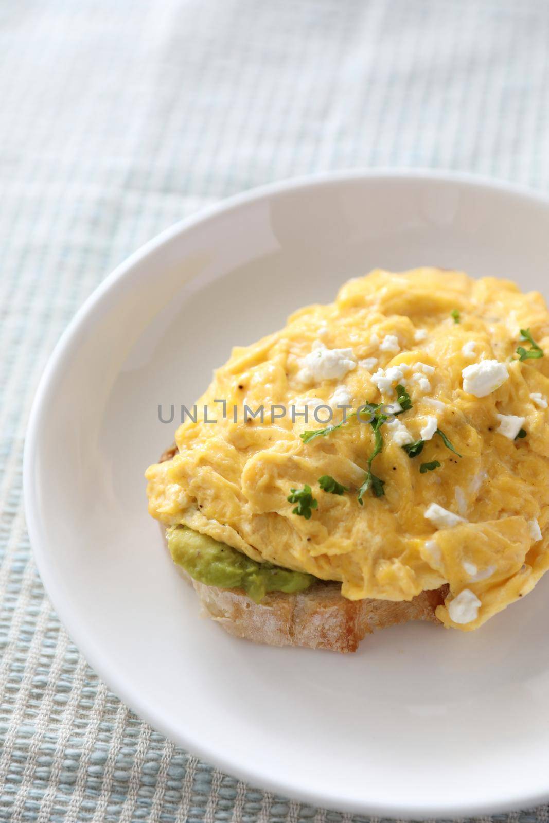 Avocado and scrambled eggs toast by piyato