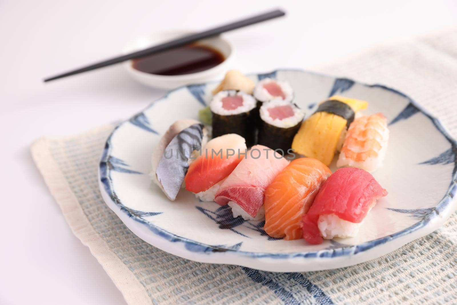 Sushi Set nigiri and sushi rolls with soy sauce and chopsticks Japanese food isolated in white background by piyato