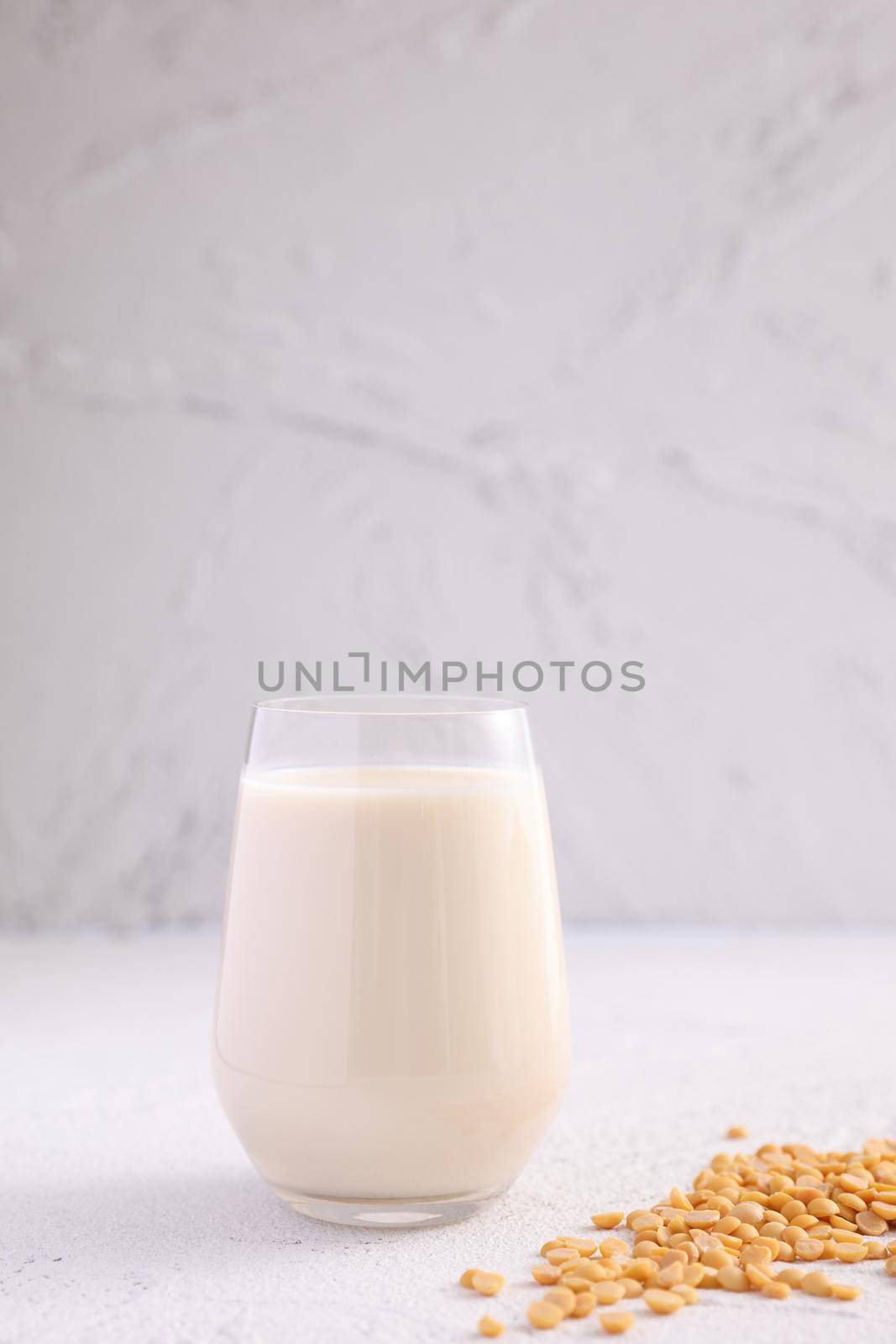 Soy milk in glass and soy bean isolated in white background by piyato