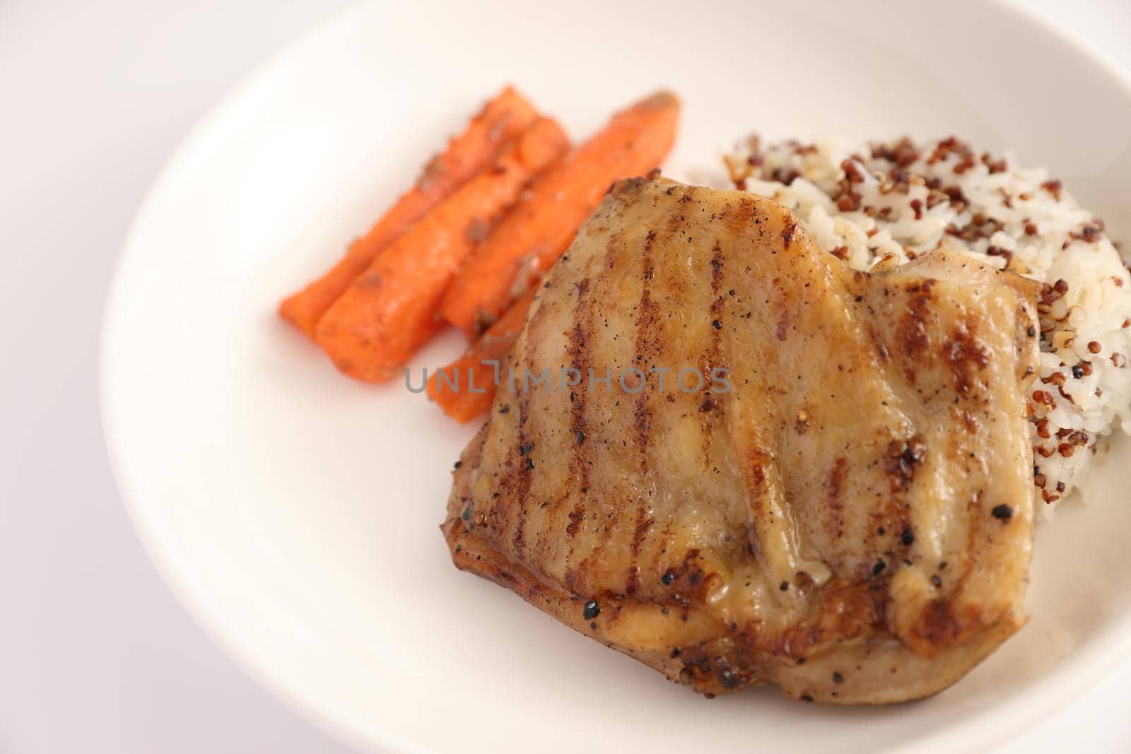 Grilled chicken with rice isolated in white background