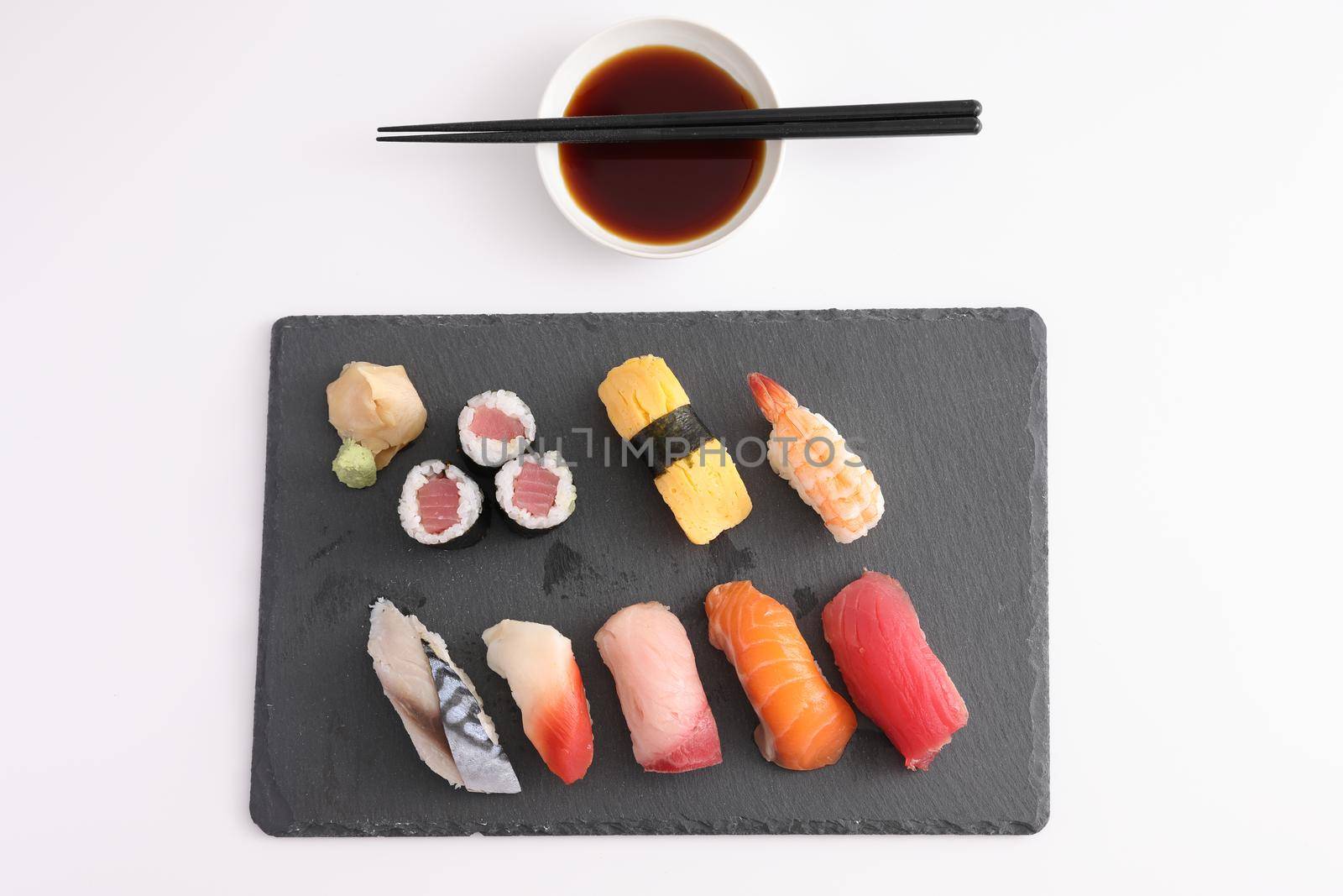 Sushi Set nigiri and sushi rolls with soy sauce and chopsticks Japanese food isolated in white background by piyato