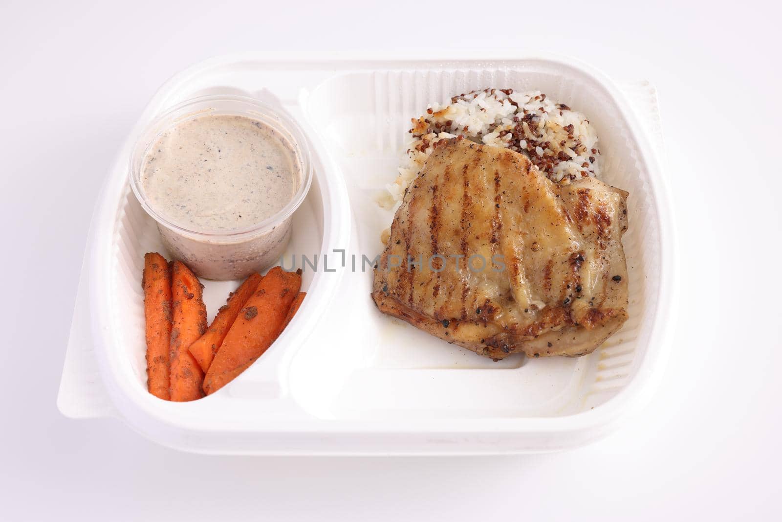 Grilled chicken with rice with delivery take home package isolated in white background by piyato