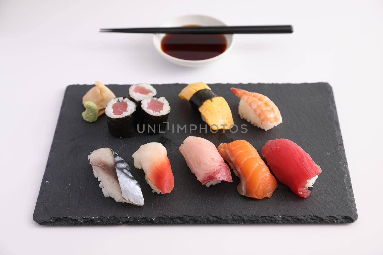 Sushi Set nigiri and sushi rolls with soy sauce and chopsticks Japanese food isolated in white background by piyato