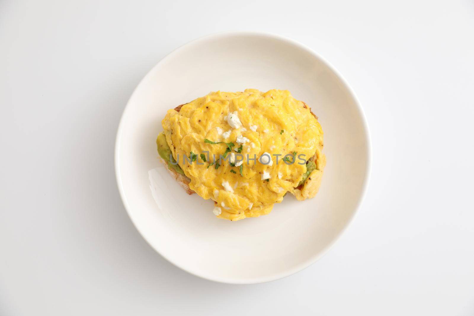 Avocado and scrambled eggs toast by piyato